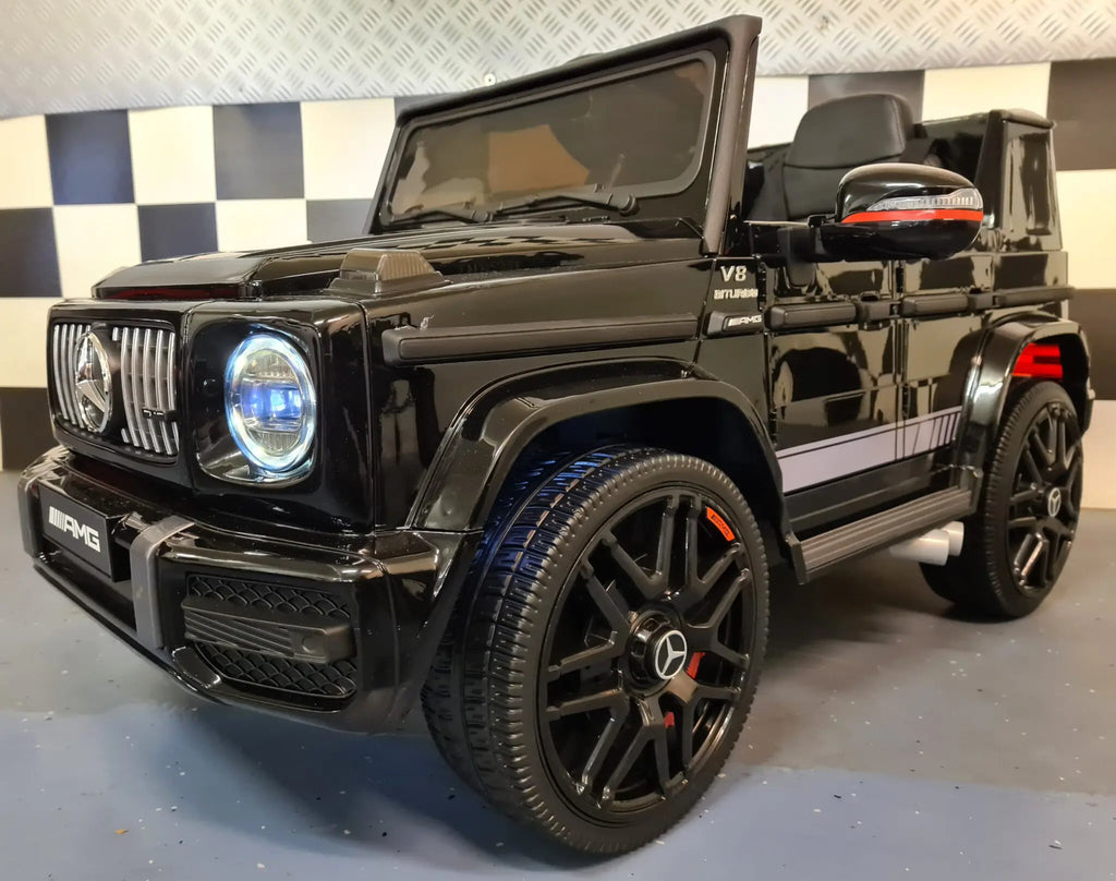 Mercedes G63 AMG in Schwarz – Kinder Elektroauto lizenziert mit Ledersitzen, Vollgummireifen, Fernbedienung, MP3, Stoßdämpfer