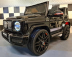 Mercedes G63 AMG in Schwarz – Kinder Elektroauto lizenziert mit Ledersitzen, Vollgummireifen, Fernbedienung, MP3, Stoßdämpfer