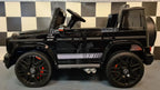 Mercedes G63 AMG in Schwarz – Kinder Elektroauto lizenziert mit Ledersitzen, Vollgummireifen, Fernbedienung, MP3, Stoßdämpfer