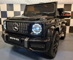 Mercedes G63 AMG in Schwarz – Kinder Elektroauto lizenziert mit Ledersitzen, Vollgummireifen, Fernbedienung, MP3, Stoßdämpfer